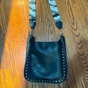 Black purse with camouflage strap